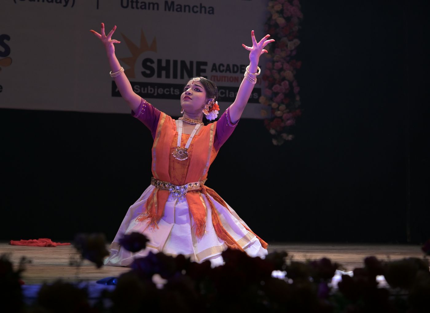 Rabindranritya dancer reaching both arms upward in an expressive pose